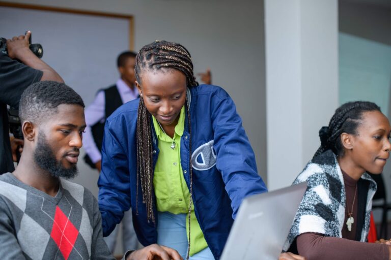 Students reviewing advanced code on a screen